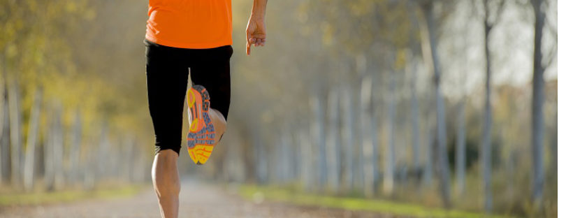 sport man with strong calves muscle running outdoors in off road