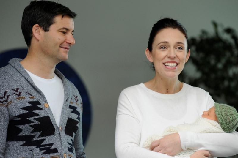 New Zealand Prime Minister Jacinda Ardern carries her newborn baby as she walks out of the Auckland Hospital in New Zealand