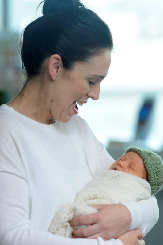 New Zealand Prime Minister Jacinda Ardern carries her newborn baby as she walks out of the Auckland Hospital in New Zealand