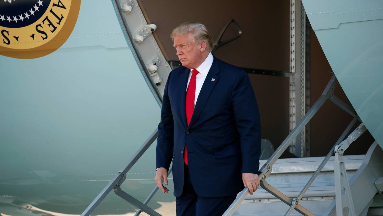 U.S. President Donald Trump walks from Air Force One as he arrives in Dallas, Texas